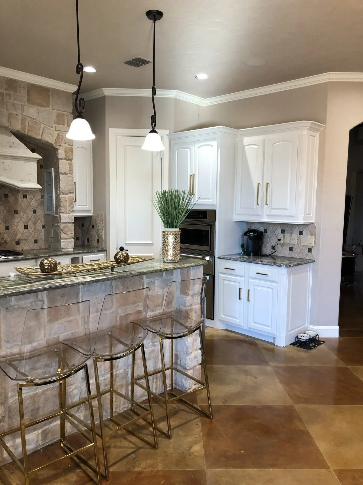 Kitchen with white refinished cabinets, stone accents, and neutral walls
